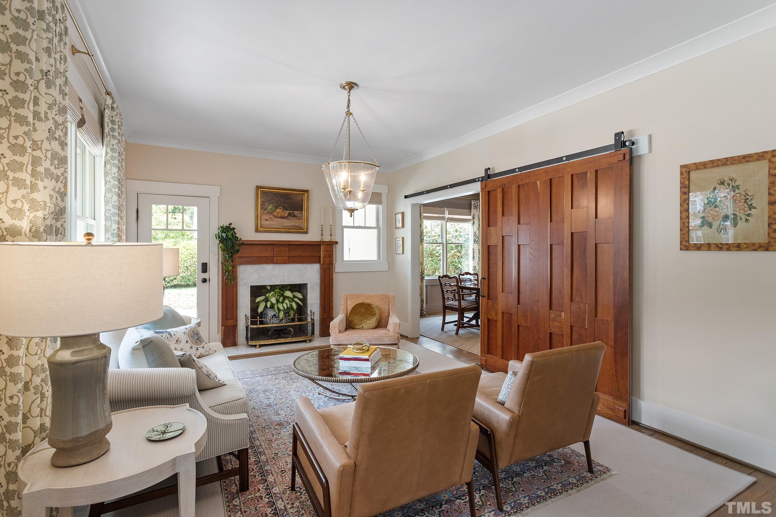 2511 Beechridge Road Raleigh, NC 27608 - Photo 8 of 45 a living room with furniture a fireplace and a window