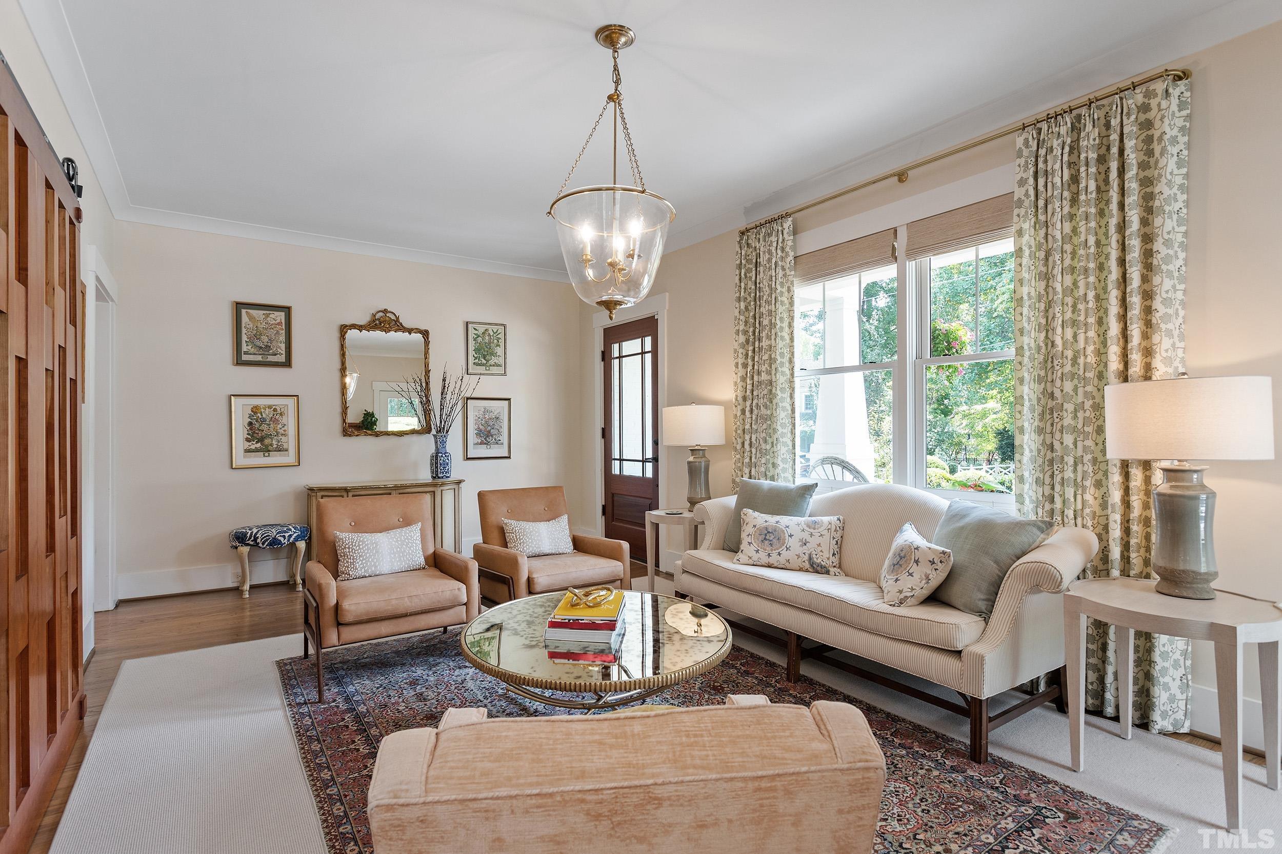2511 Beechridge Road Raleigh, NC 27608 - Photo 10 of 45 a living room with furniture chandelier and a large window