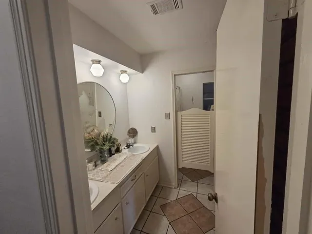 a bathroom with a sink and mirror