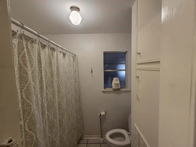 a bathroom with a shower a toilet and a sink