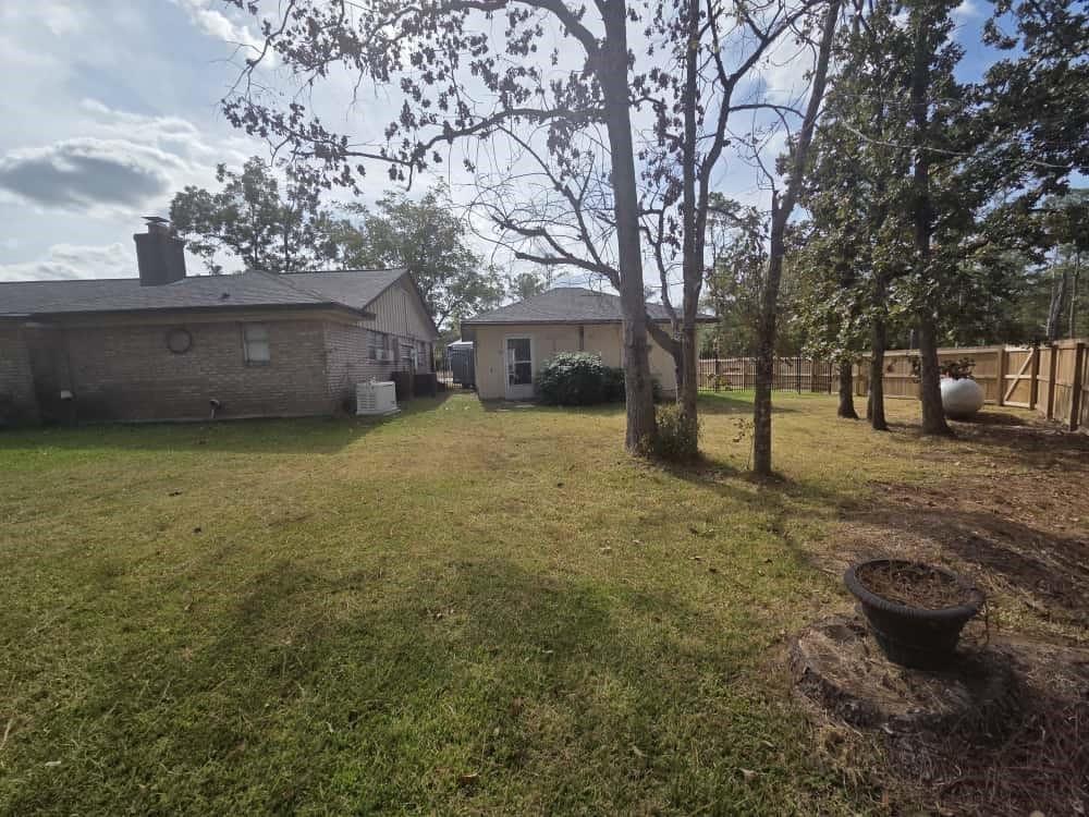252 Parkside Loop Brookeland, TX 75931 - Photo 22 of 22 a view of a backyard with plants and trees