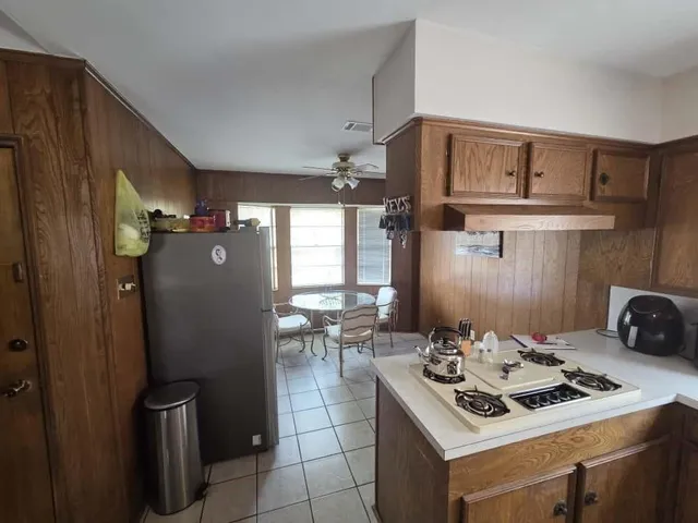 a kitchen with a stove and a refrigerator