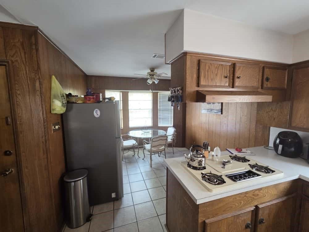 252 Parkside Loop Brookeland, TX 75931 - Photo 5 of 22 a kitchen with a stove and a refrigerator