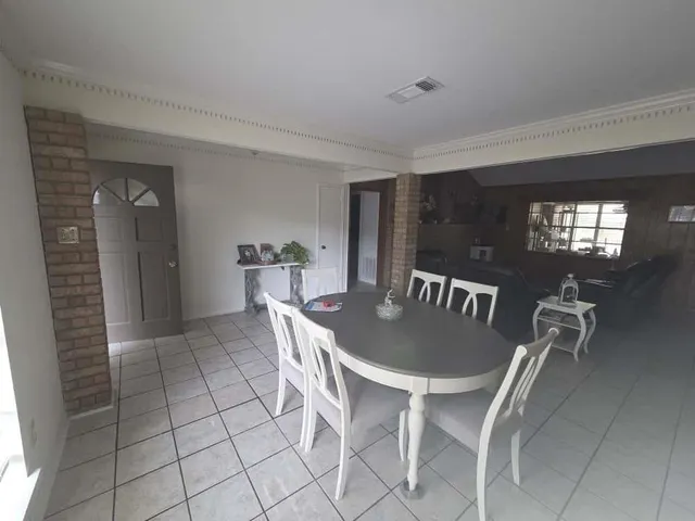 a dining room with furniture and window