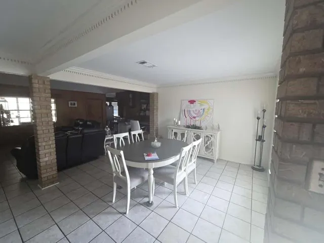 a dining room with furniture and window