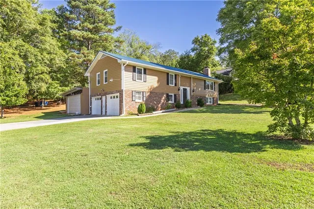 a front view of house with yard and green space