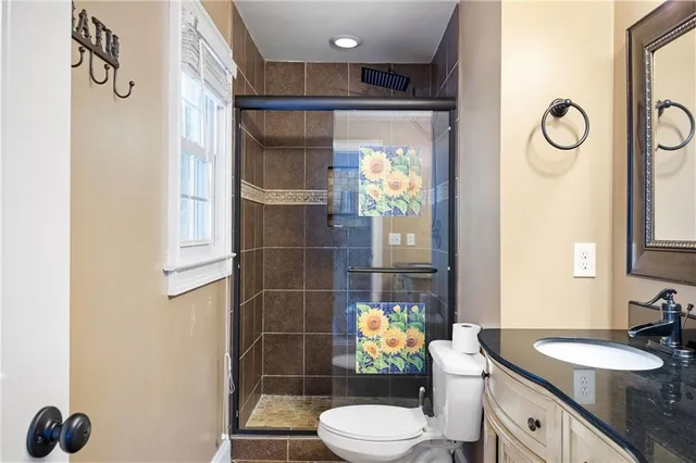 a bathroom with a sink mirror vanity and toilet