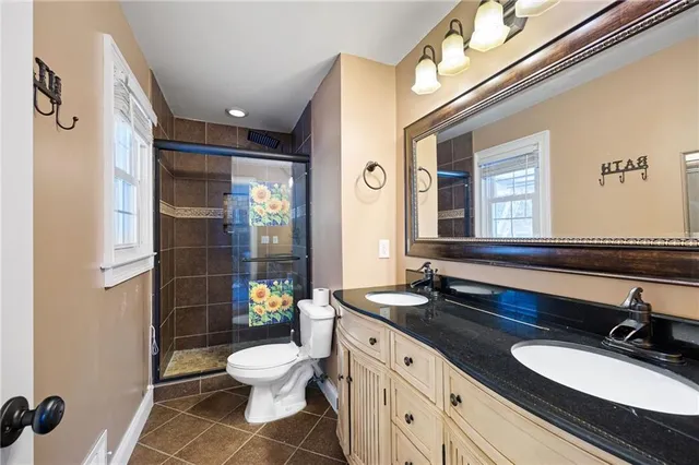 a bathroom with a toilet a sink and mirror