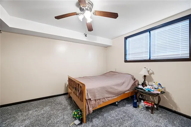 a bed room with a bed and a ceiling fan