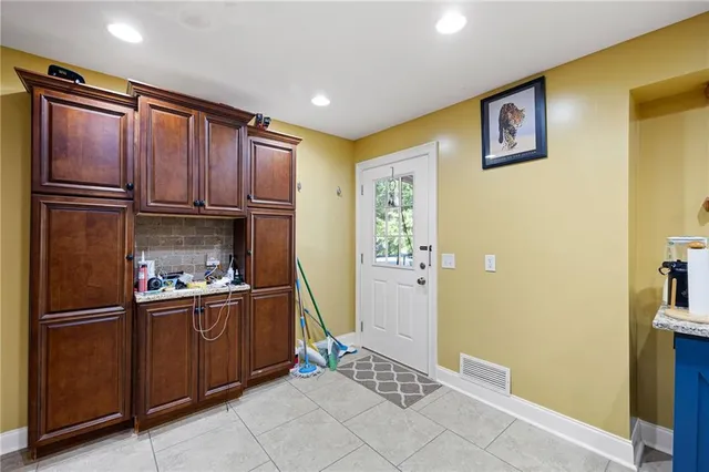 a kitchen with stainless steel appliances granite countertop a refrigerator and a sink