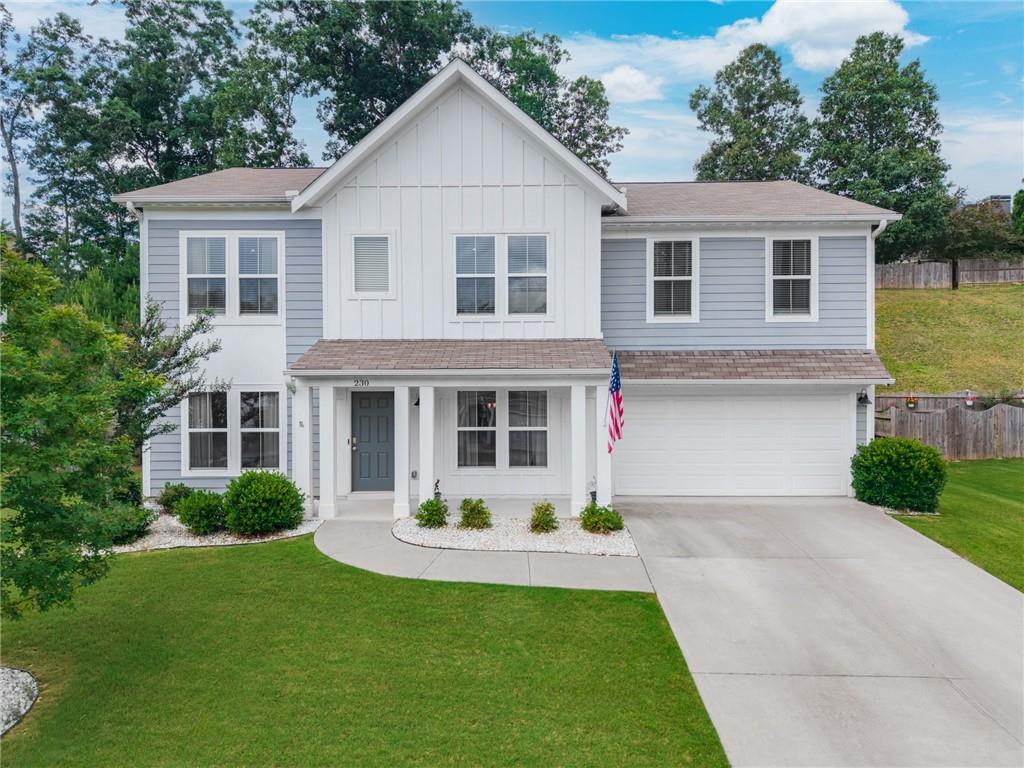 230 Augusta Walk Canton, GA 30114 - Photo 7 of 56 a front view of a house with a yard and porch