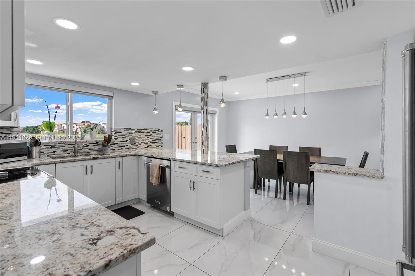 5262 Southwest 153rd Court Miami, FL 33185 - Photo 12 of 47 a kitchen with white cabinets and white appliances