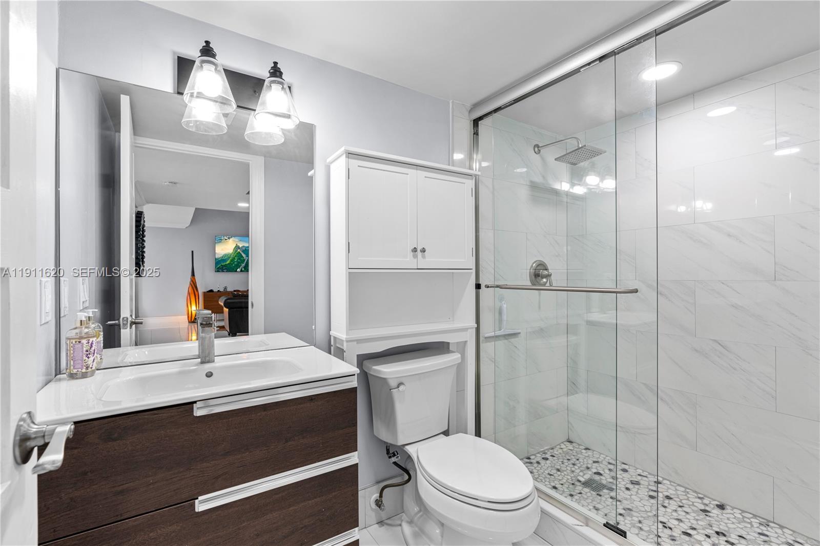 5262 Southwest 153rd Court Miami, FL 33185 - Photo 16 of 47 a bathroom with a sink a toilet a mirror and shower