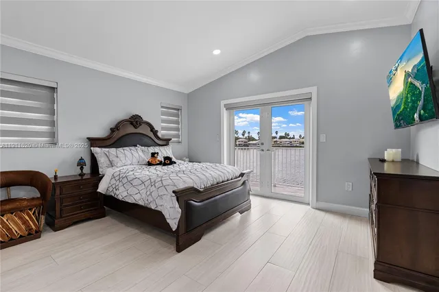 a bedroom with a bed and a flat screen television
