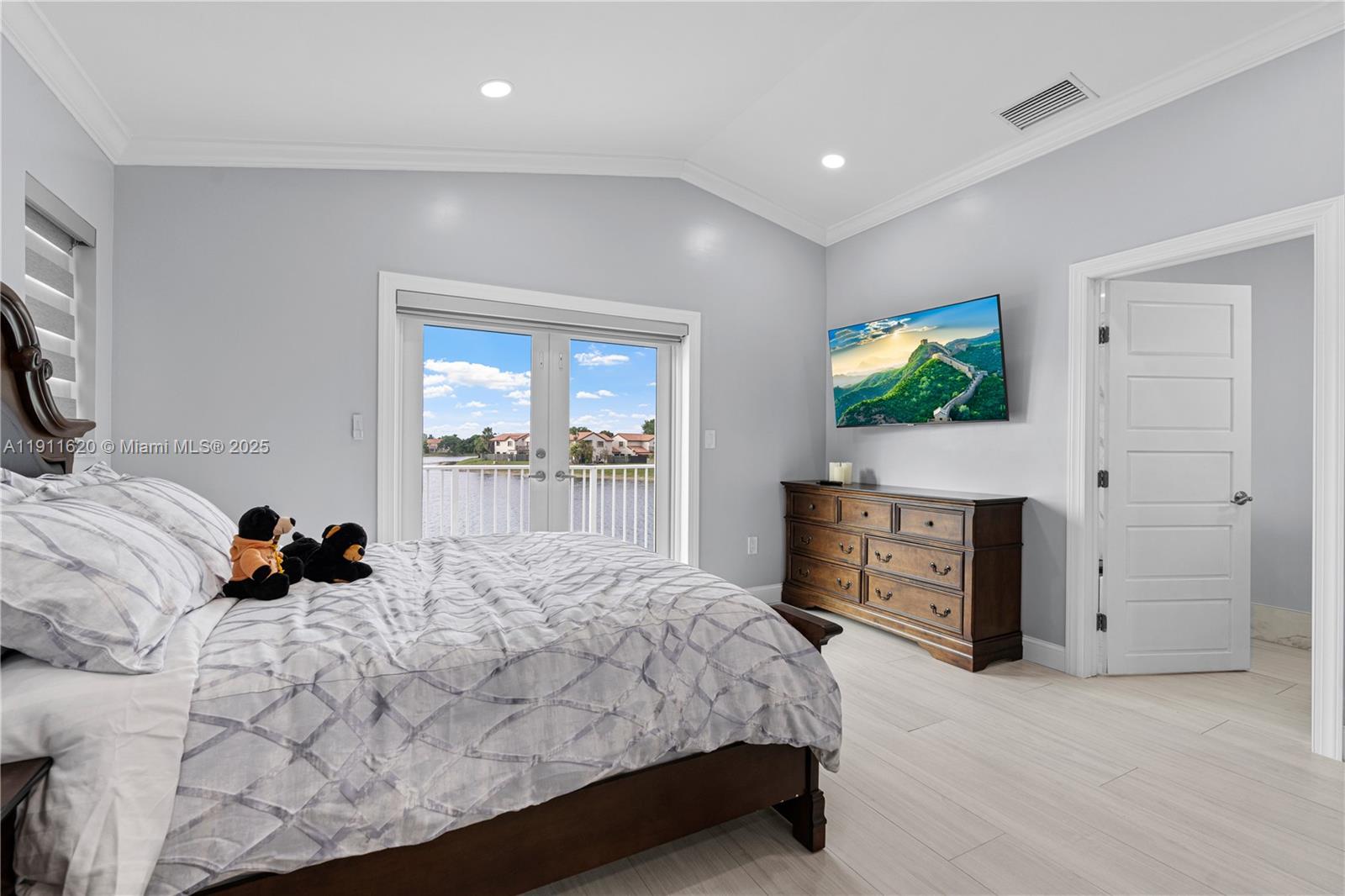 5262 Southwest 153rd Court Miami, FL 33185 - Photo 19 of 47 a bedroom with a bed and a flat tv screen on dresser