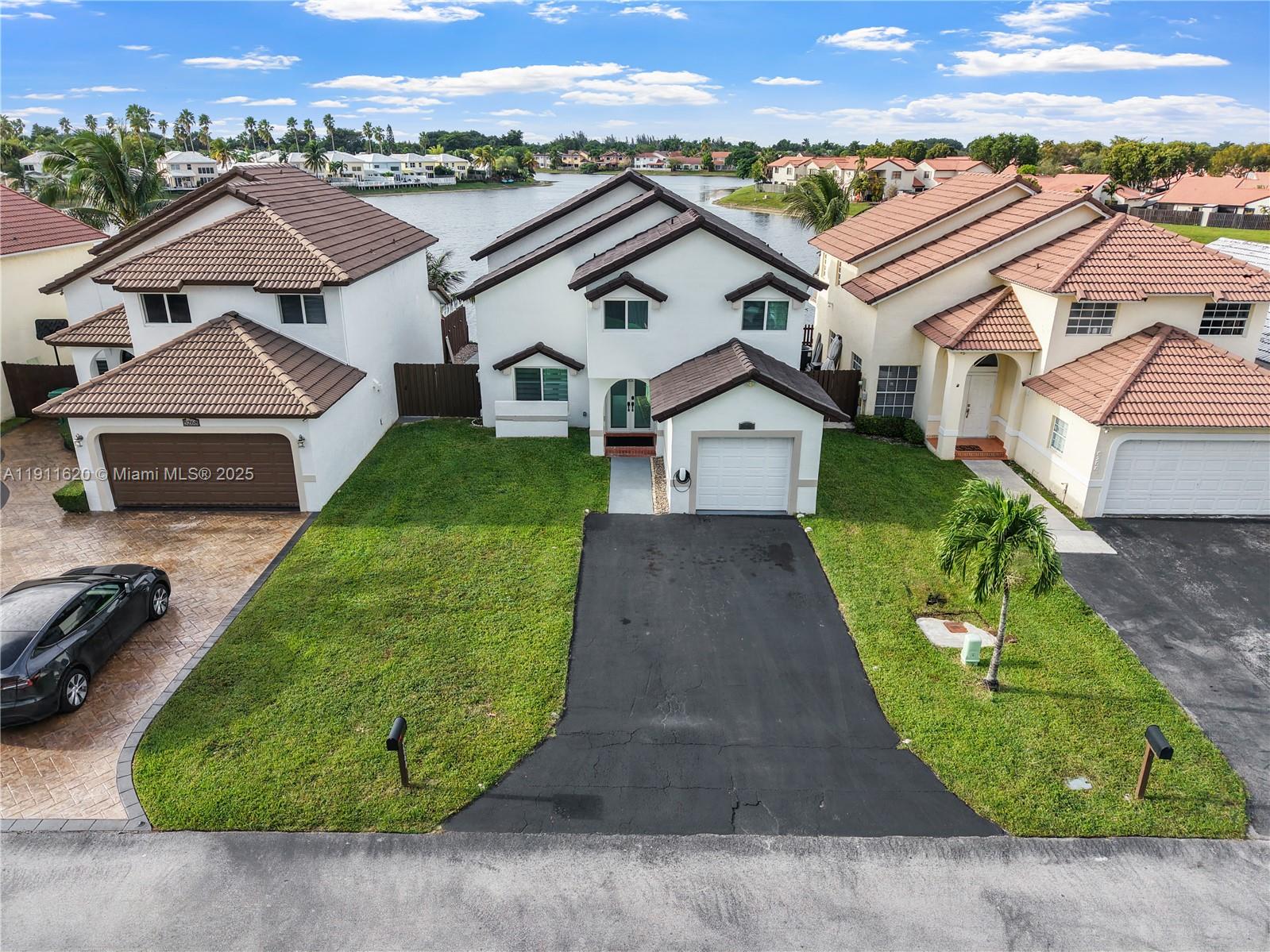 5262 Southwest 153rd Court Miami, FL 33185 - Photo 2 of 47 an aerial view of a house with a garden and trees