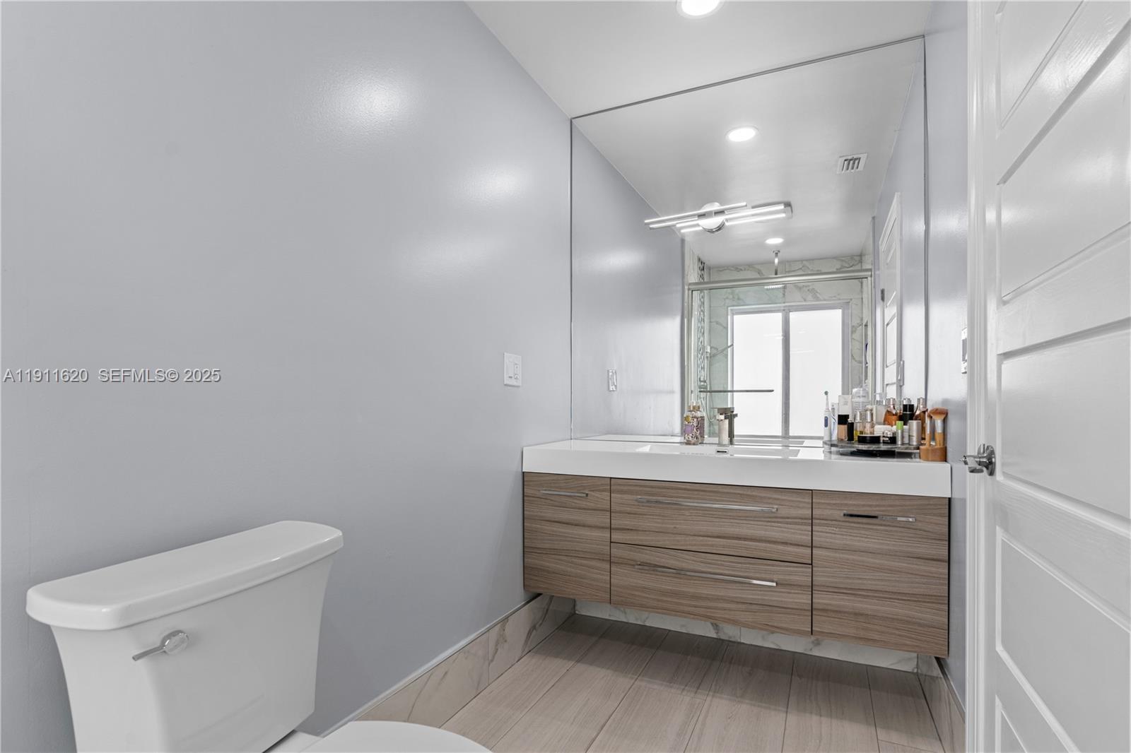 5262 Southwest 153rd Court Miami, FL 33185 - Photo 21 of 47 a bathroom with a sink a toilet and a mirror