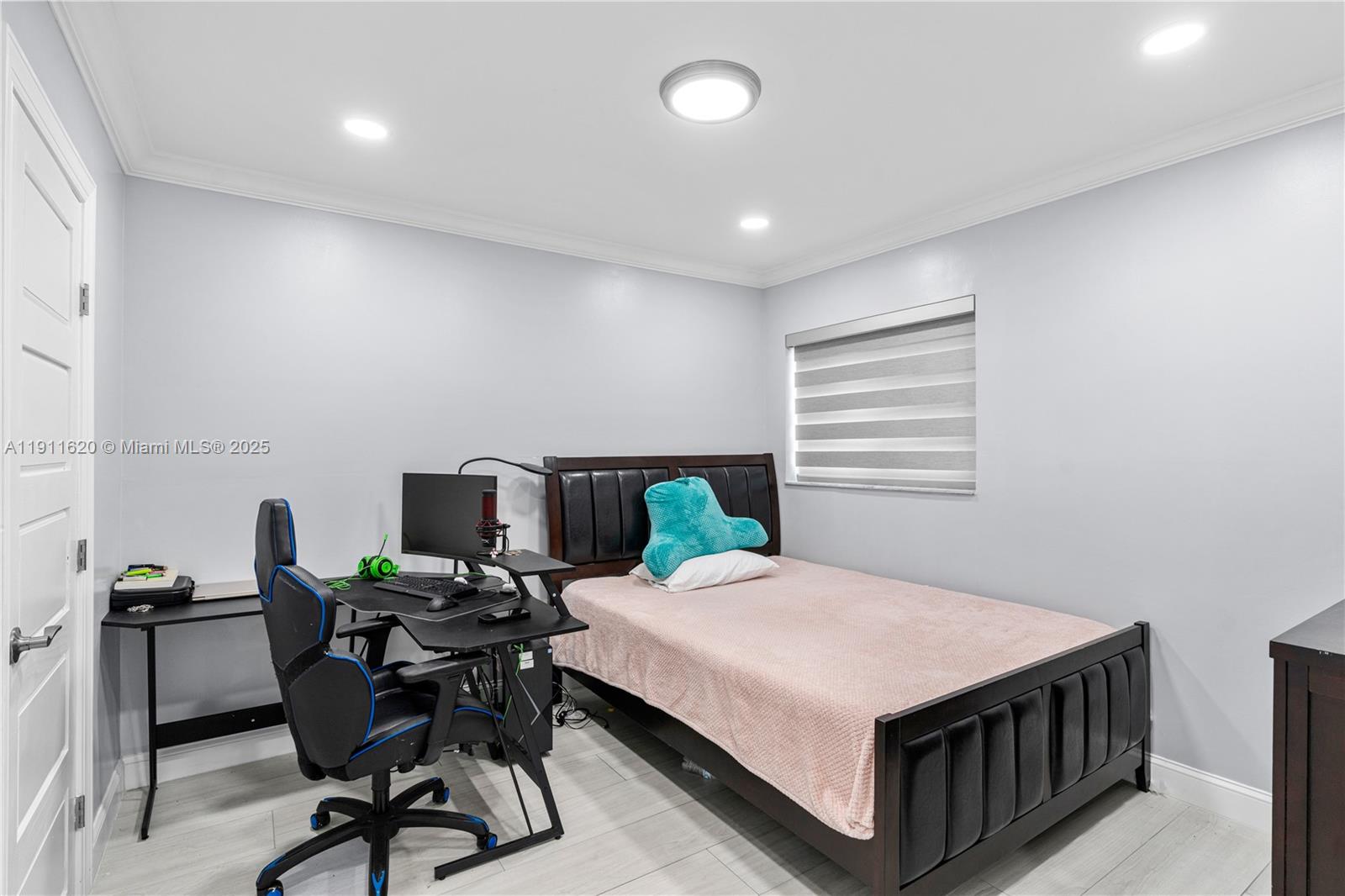 5262 Southwest 153rd Court Miami, FL 33185 - Photo 24 of 47 a bedroom with a bed a table and a chair