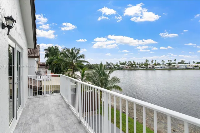 a view of a lake in middle of a yard
