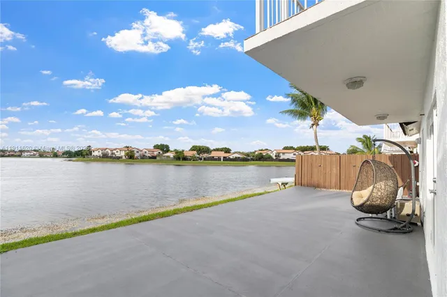 a view of a lake with houses in the back