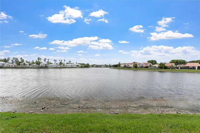 an aerial view of a house with a lake view