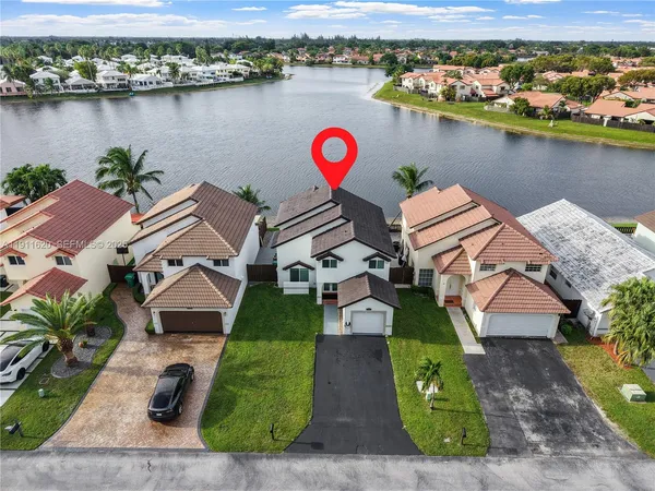 an aerial view of a house with a lake view