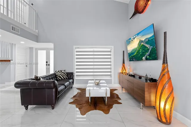 a living room with furniture and a flat screen tv