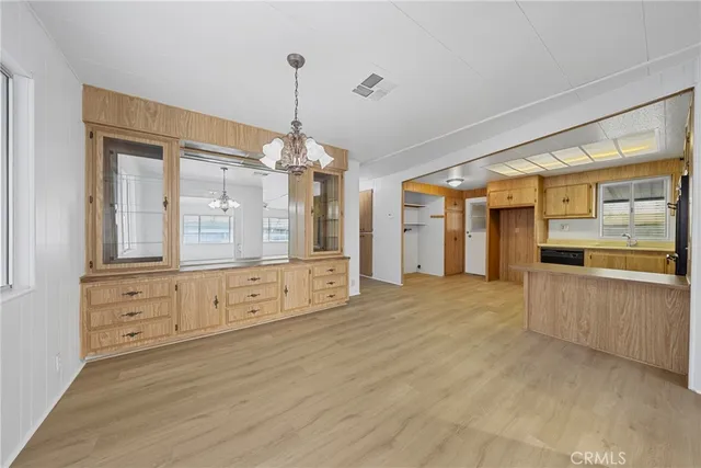 a spacious bedroom with a bed and a large mirror