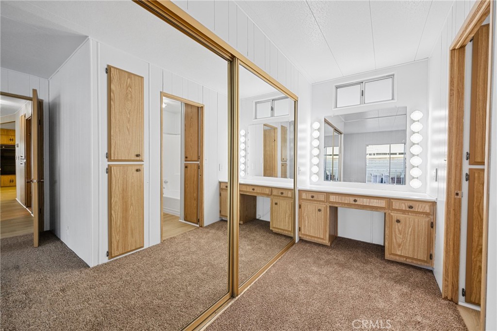 950 California Street, Unit 82 Calimesa, CA 92320 - Photo 17 of 49 a large bathroom with a large mirror vanity and shower