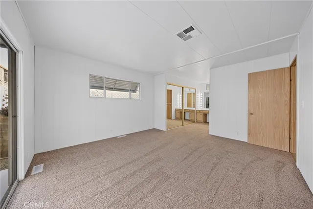 an empty room with windows and closet