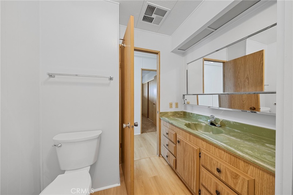 950 California Street, Unit 82 Calimesa, CA 92320 - Photo 23 of 49 a bathroom with a granite countertop sink and a toilet