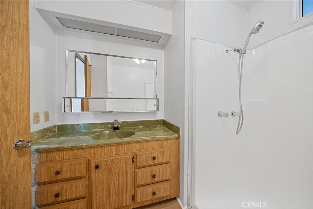 950 California Street, Unit 82 Calimesa, CA 92320 - Photo 24 of 49 a bathroom with a granite countertop sink and mirror
