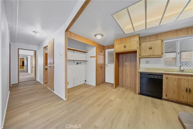 a kitchen with stainless steel appliances granite countertop a sink a stove and cabinets