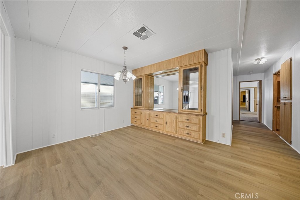950 California Street, Unit 82 Calimesa, CA 92320 - Photo 29 of 49 a view of an empty room with window and wooden floor