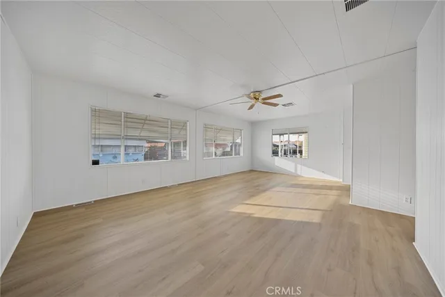a view of an empty room with a kitchen
