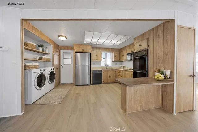 a kitchen with refrigerator sink and stove top oven