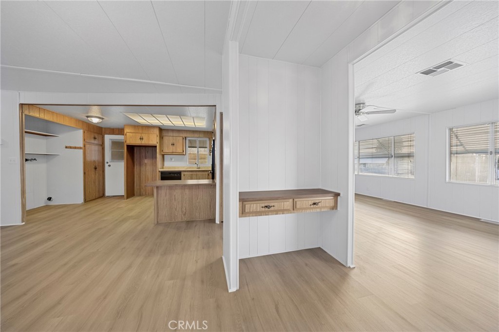 950 California Street, Unit 82 Calimesa, CA 92320 - Photo 32 of 49 wooden floor in an empty room with a kitchen
