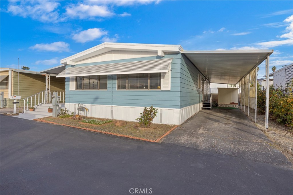 950 California Street, Unit 82 Calimesa, CA 92320 - Photo 40 of 49 a view of a house with backyard and a tree