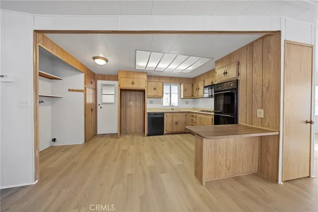 a large kitchen with cabinets and stainless steel appliances