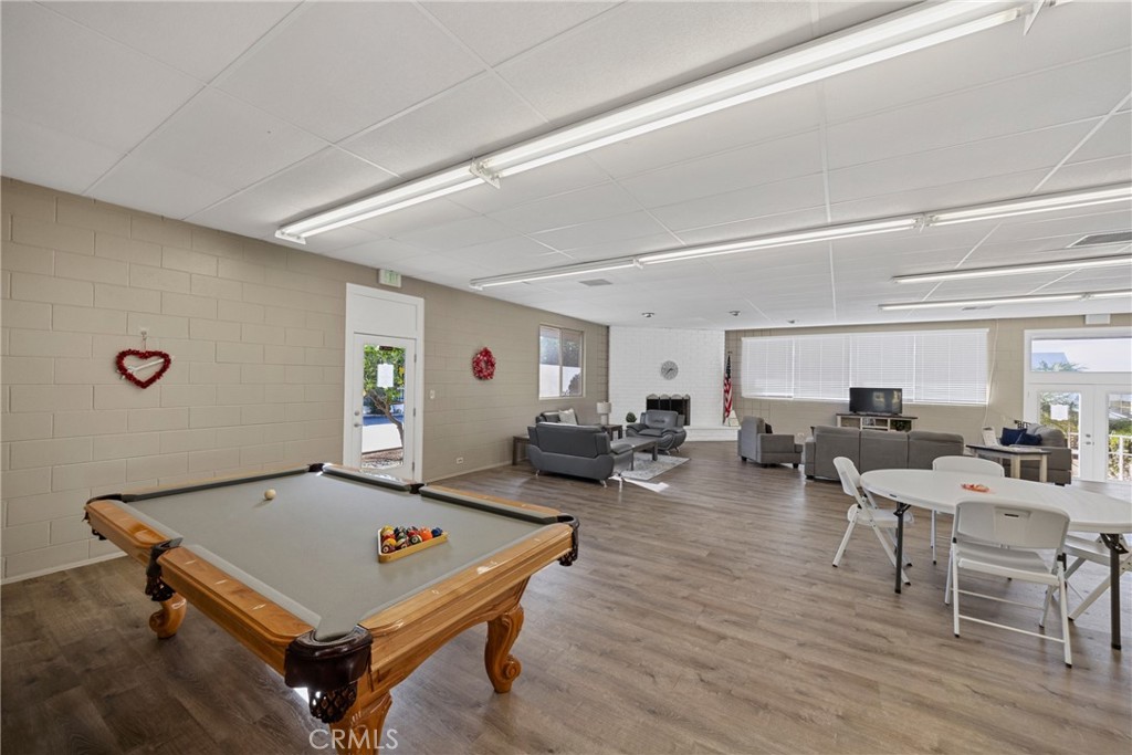 950 California Street, Unit 82 Calimesa, CA 92320 - Photo 48 of 49 a living room with furniture pool table and a wooden floor