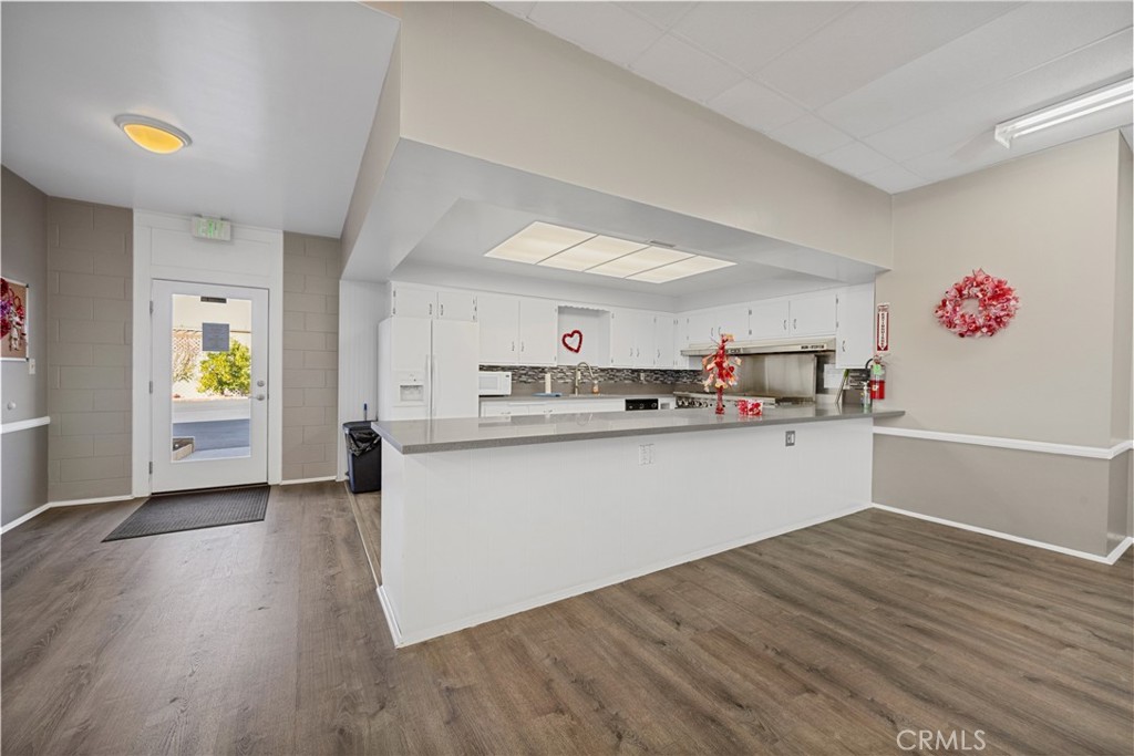 950 California Street, Unit 82 Calimesa, CA 92320 - Photo 49 of 49 a kitchen with granite countertop a refrigerator and a stove top oven