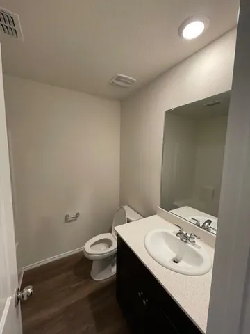 a bathroom with a sink toilet and a mirror