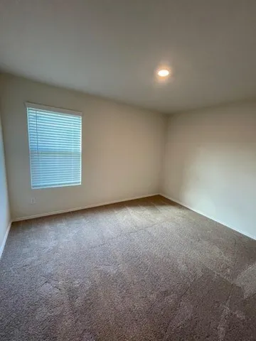 an empty room with a empty space and windows