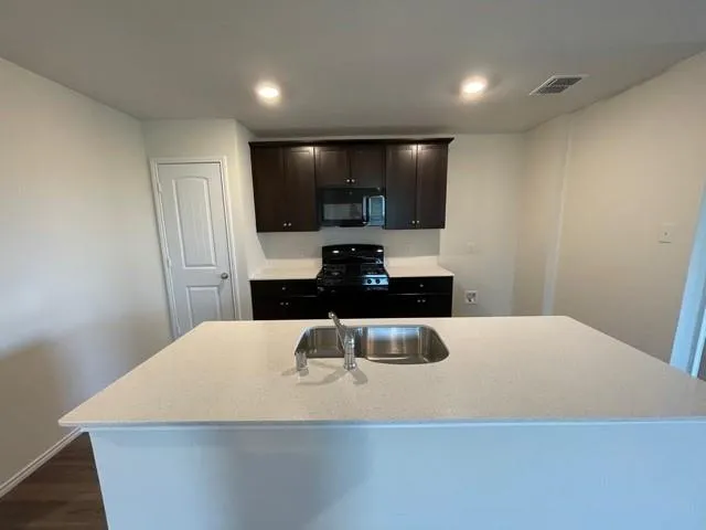 a large kitchen with a table and chairs