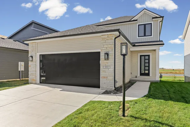 a front view of a house with a yard and garage