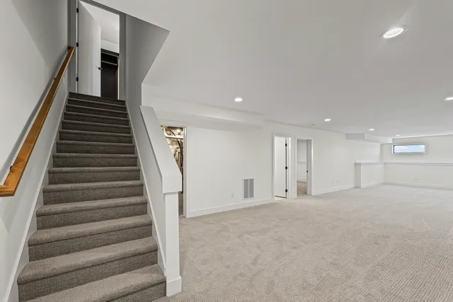 a view of an empty room with stairs