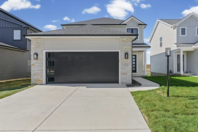 a front view of a house with a yard and garage