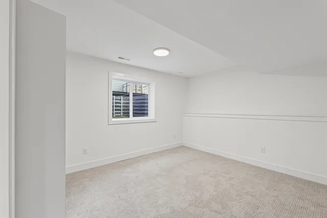 a front view of a house with a yard and trees