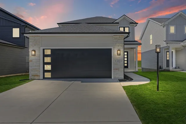 a front view of a house with a yard and garage