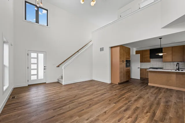 a view of a kitchen with wooden floor and a sink